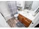 Clean bathroom with shower, tub, and wood cabinets providing functionality and comfort at 207 Meadow Lake Dr, Carrollton, GA 30116