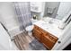 Neutral bathroom with a single sink vanity, shower, and tile accents at 207 Meadow Lake Dr, Carrollton, GA 30116