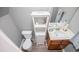 Cozy bathroom featuring a toilet, modern vanity, sink, and convenient storage cabinet at 207 Meadow Lake Dr, Carrollton, GA 30116