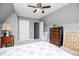 Bedroom featuring neutral carpet, gray walls, a ceiling fan, dresser, and a bed at 207 Meadow Lake Dr, Carrollton, GA 30116