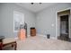 Bedroom with gray walls, neutral carpet, a window, and a glimpse into an attached bathroom at 207 Meadow Lake Dr, Carrollton, GA 30116