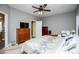 Spacious primary bedroom with ceiling fan, neutral walls, carpet, and access to ensuite bath and walk in closet at 207 Meadow Lake Dr, Carrollton, GA 30116