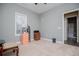 Bright bedroom with neutral carpet and paint with open door to adjoining bath at 207 Meadow Lake Dr, Carrollton, GA 30116