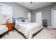 Spacious primary bedroom with neutral walls, carpet, ceiling fan, a king sized bed, and two windows at 207 Meadow Lake Dr, Carrollton, GA 30116
