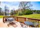Outdoor deck with dining seating and a view of trees, lake, and lawn at 207 Meadow Lake Dr, Carrollton, GA 30116