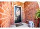 Close up of front door with brick, covered front entry, and decorations at 207 Meadow Lake Dr, Carrollton, GA 30116