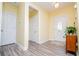 Inviting entryway with neutral walls, wood floors, and an oval glass front door at 207 Meadow Lake Dr, Carrollton, GA 30116