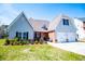 Lovely two-story home with an attached garage, brick accents, and vibrant landscaping at 207 Meadow Lake Dr, Carrollton, GA 30116