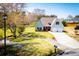 Beautiful home with a two-car garage, lush lawn, and mature trees and landscaping at 207 Meadow Lake Dr, Carrollton, GA 30116