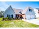 Well-maintained home featuring a two-car garage, enhanced by vibrant landscaping and a green lawn at 207 Meadow Lake Dr, Carrollton, GA 30116