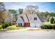 Attractive home with a two-car garage, complemented by a neatly kept lawn and picturesque landscaping at 207 Meadow Lake Dr, Carrollton, GA 30116