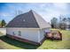 Side view of the home showcasing a deck and well-maintained lawn near a pond at 207 Meadow Lake Dr, Carrollton, GA 30116