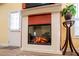 Modern fireplace with decorative trim and a cozy, warm glow, positioned by the entrance at 207 Meadow Lake Dr, Carrollton, GA 30116