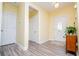 Bright entryway with wood-look flooring, white trim, and a view of the front door at 207 Meadow Lake Dr, Carrollton, GA 30116