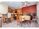 Kitchen and dining area with a central island, wooden cabinets, and neutral paint at 207 Meadow Lake Dr, Carrollton, GA 30116