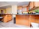 Well-equipped kitchen features stainless steel appliances, granite counters, wood cabinets, and adjacent breakfast bar at 207 Meadow Lake Dr, Carrollton, GA 30116