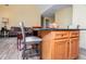 Eat-in kitchen with breakfast bar, wood cabinets, granite countertop, and adjacent living room at 207 Meadow Lake Dr, Carrollton, GA 30116
