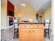 Kitchen island with granite countertop and barstool seating with a view into the living area at 207 Meadow Lake Dr, Carrollton, GA 30116