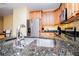 Granite counters, stainless appliances, and wood cabinets create a modern, functional kitchen space at 207 Meadow Lake Dr, Carrollton, GA 30116