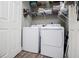 Well-organized laundry room with washer, dryer, shelving, and a convenient storage space at 207 Meadow Lake Dr, Carrollton, GA 30116