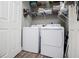 Convenient laundry area with a washer, dryer, and shelving for ample storage at 207 Meadow Lake Dr, Carrollton, GA 30116