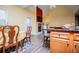 Well-lit living area showcasing open floor plan, connecting dining, fireplace, and kitchen space at 207 Meadow Lake Dr, Carrollton, GA 30116