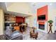 Bright living room with a fireplace, TV, open kitchen, and dining space beneath a high, vaulted ceiling at 207 Meadow Lake Dr, Carrollton, GA 30116