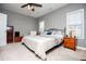 Bright main bedroom features neutral paint, ceiling fan, and two sunny windows at 207 Meadow Lake Dr, Carrollton, GA 30116