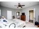 Spacious main bedroom with ceiling fan, neutral paint, adjoining bathroom, and walk-in closet at 207 Meadow Lake Dr, Carrollton, GA 30116