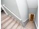 Staircase is carpeted for comfort and safety, providing access to upper and lower floors at 207 Meadow Lake Dr, Carrollton, GA 30116