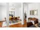 Elegant dining room with hardwood floors, modern chandelier, stylish furniture, and view into adjacent living room at 513 Boulevard Se, Atlanta, GA 30312