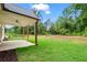 Large backyard with a covered patio, grass and a wood fence at 1698 Cunningham Sw Rd, Marietta, GA 30008
