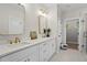 Bright bathroom with double vanity, quartz countertops, gold accents, and a glass-enclosed shower at 1698 Cunningham Sw Rd, Marietta, GA 30008