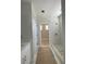 Bathroom featuring a walk-in shower with marble-look tile and gold fixtures at 1698 Cunningham Sw Rd, Marietta, GA 30008