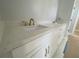Bathroom showcasing a white vanity with quartz countertop and gold hardware at 1698 Cunningham Sw Rd, Marietta, GA 30008