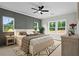 Relaxing bedroom featuring a ceiling fan, natural light from the windows, and stylish decor at 1698 Cunningham Sw Rd, Marietta, GA 30008