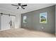 A spacious bedroom with a sliding barn door, wood-look floors, and natural lighting through large windows at 1698 Cunningham Sw Rd, Marietta, GA 30008
