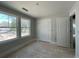 Bedroom with two windows and a double door closet offering storage, providing natural light and ventilation at 1698 Cunningham Sw Rd, Marietta, GA 30008