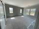 Bedroom showcasing stylish gray wall paneling, bright windows, and natural light at 1698 Cunningham Sw Rd, Marietta, GA 30008