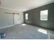 Spacious bedroom featuring gray paneled walls, a sliding barn door, and lots of natural light at 1698 Cunningham Sw Rd, Marietta, GA 30008