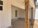 Spacious covered porch with detailed wood columns and a view of the home's exterior finishes at 1698 Cunningham Sw Rd, Marietta, GA 30008