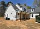 Charming two-story home with white siding, a gray roof, and a welcoming covered porch with wooden columns at 1698 Cunningham Sw Rd, Marietta, GA 30008