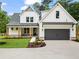 Beautiful new construction home featuring board and batten siding and a spacious driveway at 1698 Cunningham Sw Rd, Marietta, GA 30008