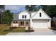 Charming two-story home features a covered porch, gabled roof and an attached garage at 1698 Cunningham Sw Rd, Marietta, GA 30008