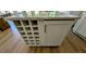 Kitchen island with wine rack and cabinets on hardwood floor at 1698 Cunningham Sw Rd, Marietta, GA 30008