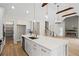 Spacious kitchen with granite countertops, stainless steel appliances, a large island, and wood beam accents at 1698 Cunningham Sw Rd, Marietta, GA 30008
