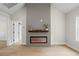 Modern living room with an electric fireplace, wood accent wall, and bright lighting at 1698 Cunningham Sw Rd, Marietta, GA 30008