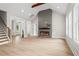 Bright living room with an electric fireplace, wood floors, and staircase at 1698 Cunningham Sw Rd, Marietta, GA 30008