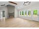 Open living space with an electric fireplace, wood floors, and lots of natural light at 1698 Cunningham Sw Rd, Marietta, GA 30008
