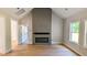 Open-concept living room featuring a gray fireplace and large windows for natural light at 1698 Cunningham Sw Rd, Marietta, GA 30008